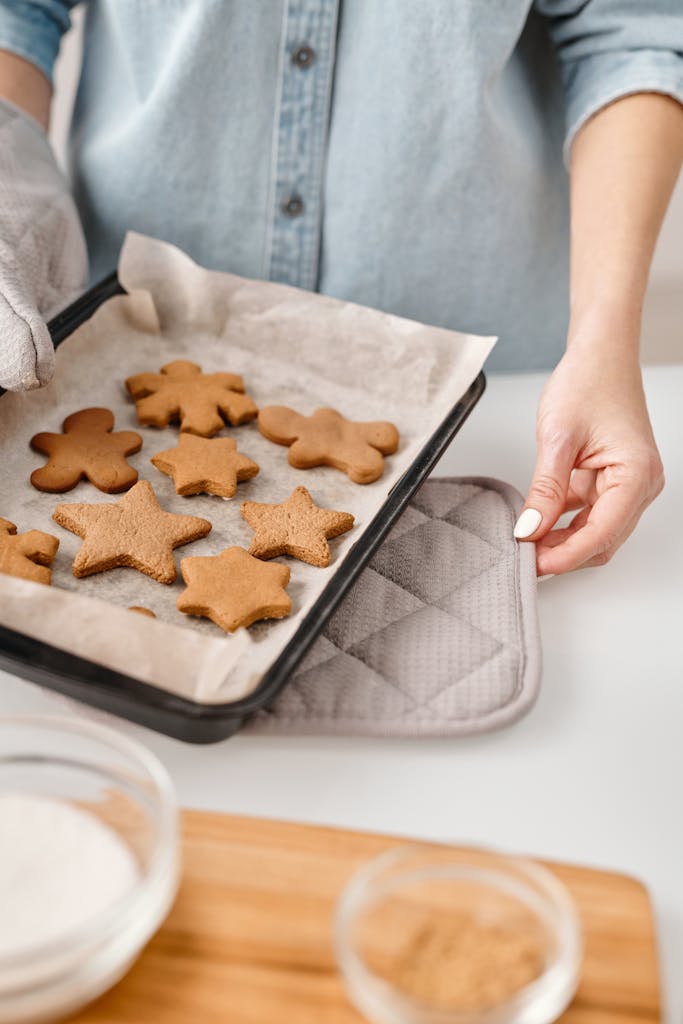 Close-up of freshly baked gingerbread cookies on a tray in a home kitchen.